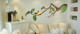 An example of wall decoration with a sticker in the shape of a bird on a branch in the living room
